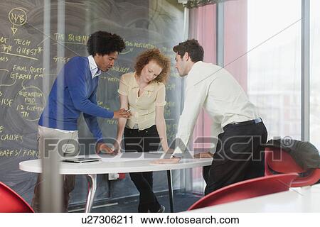 Stock Image - Business people talking in meeting. Fotosearch