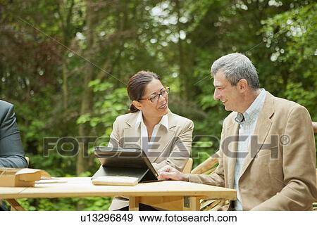 Business people talking in meeting View Large Photo Image Stock Photo - Business people talking in meeting. Fotosearch