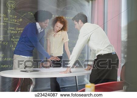 Stock Photo - Business people talking in meeting. Fotosearch