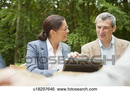 Stock Photograph - Business people talking in meeting. Fotosearch