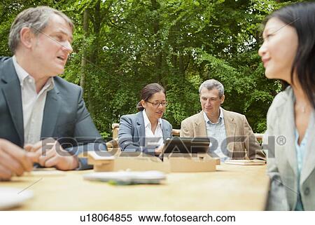 Stock Photography - Business people talking in meeting. Fotosearch