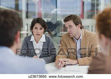 Stock Photography - Business people talking in meeting. Fotosearch