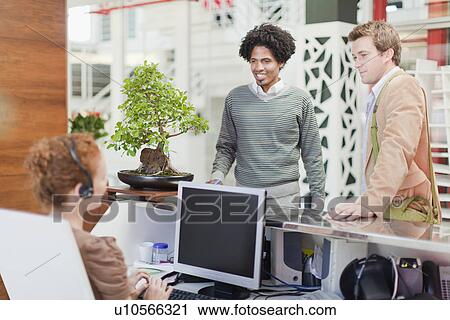 Stock Image - Business people talking in office. Fotosearch