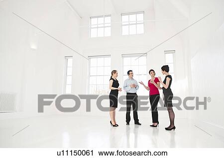 Stock Image - Business people talking in office. Fotosearch