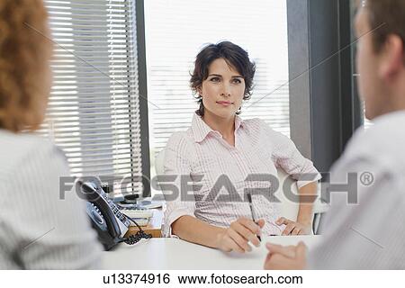 Business people talking in office View Large Photo Image Stock Photograph - Business people talking in office. Fotosearch