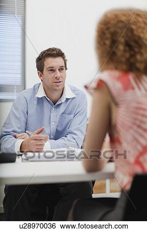 Stock Photograph - Business people talking in office. Fotosearch