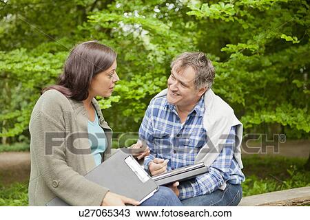 Business people with clipboards in park View Large Photo Image Stock Image - Business people with clipboards in park. Fotosearch