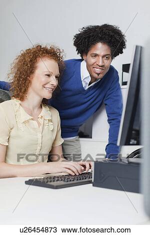 Stock Image - Business people working at computer. Fotosearch
