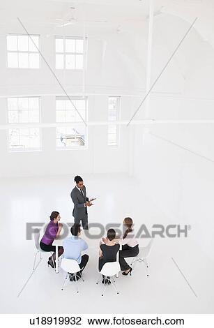 Stock Image - Businessman giving presentation. Fotosearch