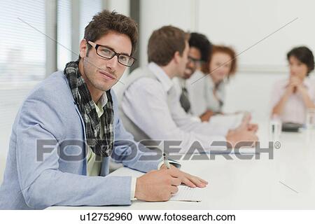 Businessman making notes in meeting View Large Photo Image Stock Image - Businessman making notes in meeting. Fotosearch