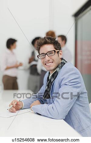 Stock Photo - Businessman making notes in meeting. Fotosearch