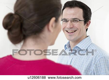 Businessman smiling in office View Large Photo Image Stock Photo - Businessman smiling in office. Fotosearch