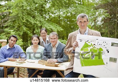 Businessman with map in meeting View Large Photo Image Stock Photo - Businessman with map in meeting. Fotosearch