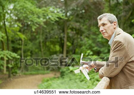 Businessman with propeller on balcony View Large Photo Image Stock Image - Businessman with propeller on balcony. Fotosearch