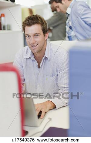 Businessman working on laptop View Large Photo Image Stock Photograph - Businessman working on laptop. Fotosearch