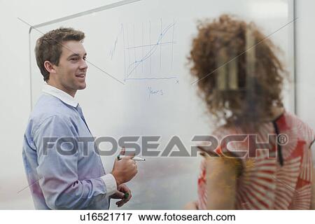 Businessman writing on whiteboard View Large Photo Image Stock Photo - Businessman writing on whiteboard. Fotosearch