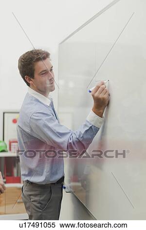 Stock Photography - Businessman writing on whiteboard. Fotosearch