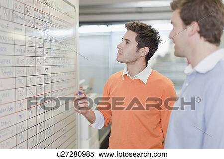 Businessman writing on whiteboard View Large Photo Image Stock Photography - Businessman writing on whiteboard. Fotosearch