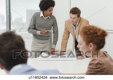 Picture - Businessmen talking in meeting. Fotosearch