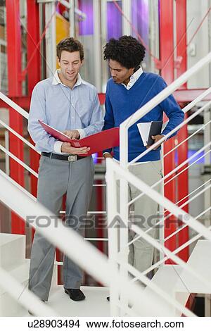Businessmen talking in office View Large Photo Image Picture - Businessmen talking in office. Fotosearch