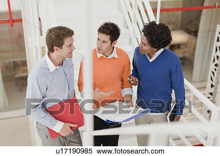 Businessmen talking in office View Large Photo Image Stock Photography - Businessmen talking in office. Fotosearch