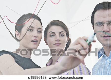 Businesswoman drawing on glass View Large Photo Image Stock Image - Businesswoman drawing on glass. Fotosearch