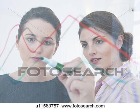 Stock Photo - Businesswoman drawing on glass. Fotosearch