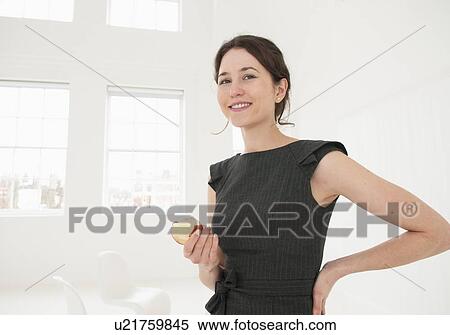 Businesswoman eating apple in office View Large Photo Image Stock Photography - Businesswoman eating apple in office. Fotosearch