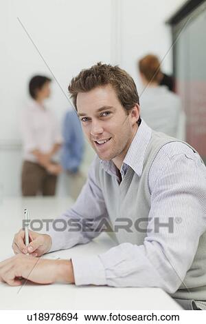 Businesswoman making notes in meeting View Large Photo Image Picture - Businesswoman making notes in meeting. Fotosearch