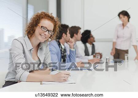 Businesswoman making notes in meeting View Large Photo Image Stock Image - Businesswoman making notes in meeting. Fotosearch