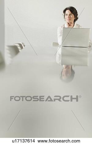 Businesswoman reflected in table View Large Photo Image Picture - Businesswoman reflected in table. Fotosearch