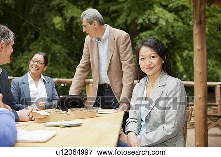 Businesswoman sitting at conference desk View Large Photo Image Stock Photo - Businesswoman sitting at conference desk. Fotosearch