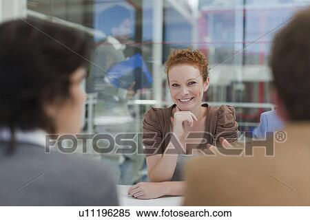 Businesswoman smiling in meeting View Large Photo Image Stock Photography - Businesswoman smiling in meeting. Fotosearch
