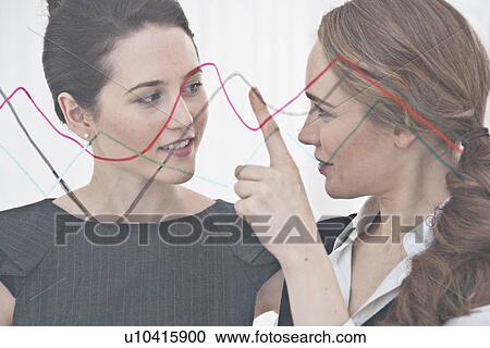 Stock Image - Businesswoman talking in office. Fotosearch
