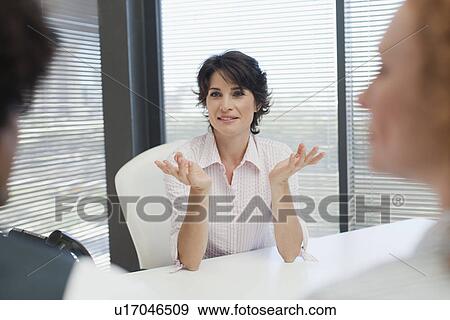 Stock Photo - Businesswoman talking in office. Fotosearch