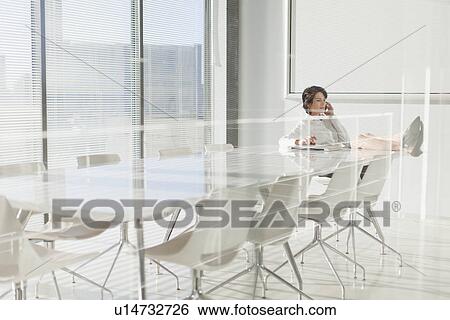 Stock Photograph - Businesswoman talking on cell phone. Fotosearch