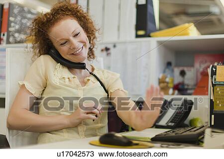 Businesswoman talking on phone at desk View Large Photo Image Stock Image - Businesswoman talking on phone at desk. Fotosearch