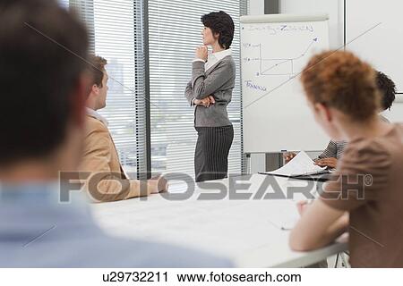 Stock Image - Businesswoman thinking in meeting. Fotosearch