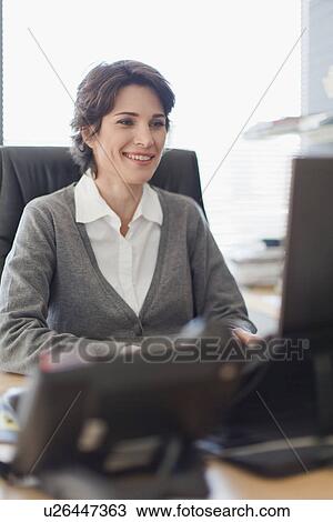 Businesswoman working on computer View Large Photo Image Stock Image - Businesswoman working on computer. Fotosearch
