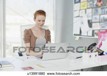 Businesswoman working on laptop View Large Photo Image Stock Image - Businesswoman working on laptop. Fotosearch