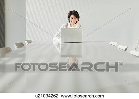 Businesswoman working on laptop View Large Photo Image Stock Image - Businesswoman working on laptop. Fotosearch
