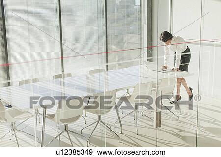 Stock Photo - Businesswoman working on laptop. Fotosearch