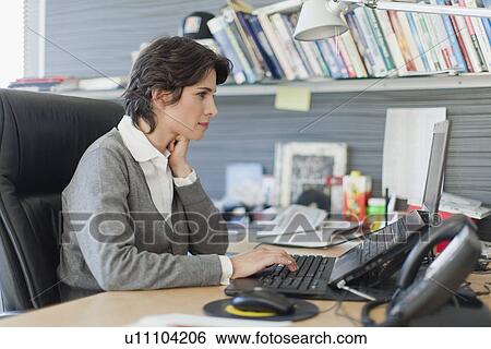 Stock Photograph - Businesswoman working on laptop. Fotosearch