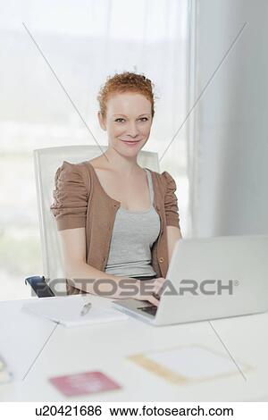 Businesswoman working on laptop View Large Photo Image Stock Photograph - Businesswoman working on laptop. Fotosearch