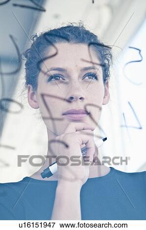 Businesswoman writing on glass View Large Photo Image Stock Photo - Businesswoman writing on glass. Fotosearch