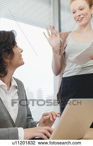 Businesswomen talking in meeting View Large Photo Image Stock Image - Businesswomen talking in meeting. Fotosearch