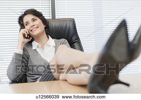 Businesswomen talking on cell phone View Large Photo Image Stock Photo - Businesswomen talking on cell phone. Fotosearch