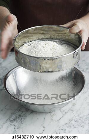 Chef sifting flour in bowl View Large Photo Image Stock Image - Chef sifting flour in bowl. Fotosearch