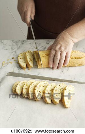 Chef slicing bread in kitchen View Large Photo Image Stock Photography - Chef slicing bread in kitchen. Fotosearch