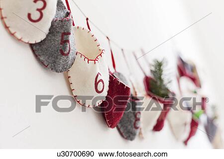 Stock Image - Close up of advent calendar on wall. Fotosearch